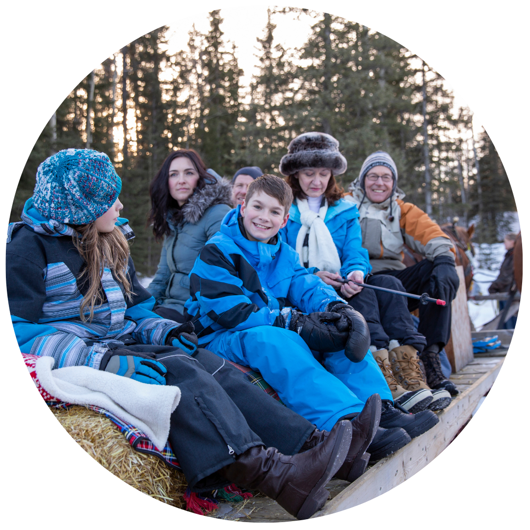 Happy multi-generational family enjoying a hayride in the snow